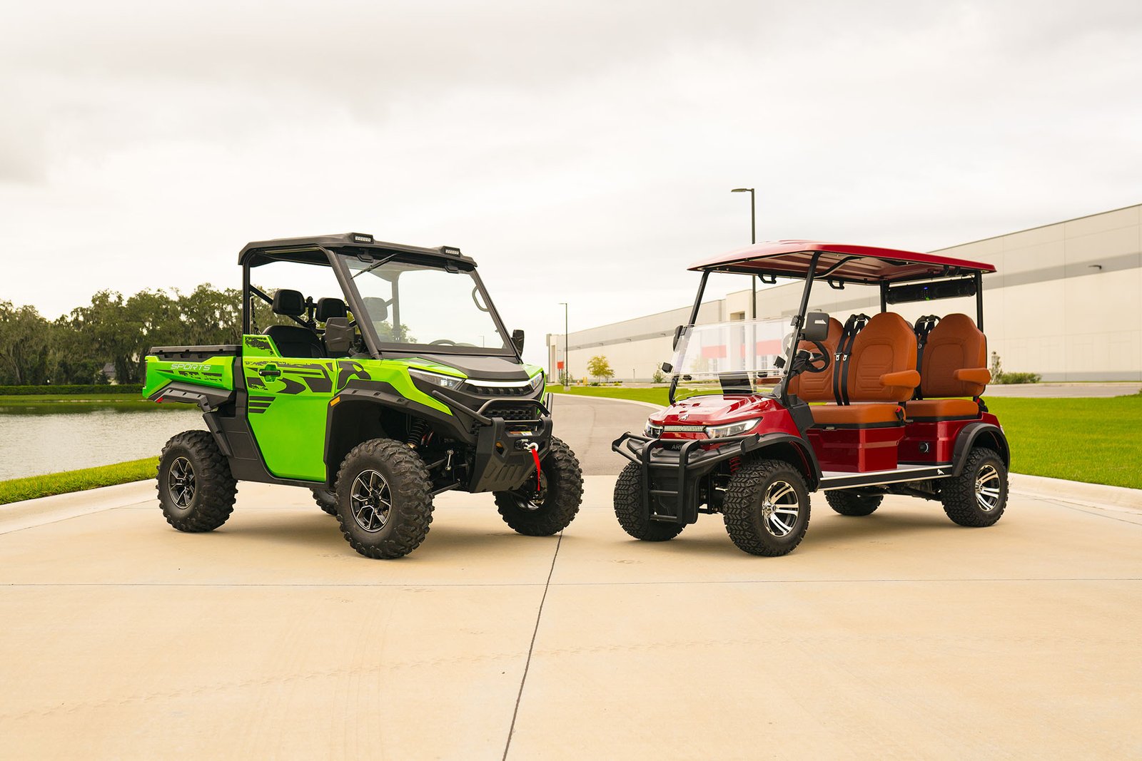 Green Sabre UTV and red Aries electric golf cart
